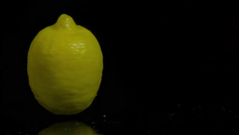 single lemon on black background