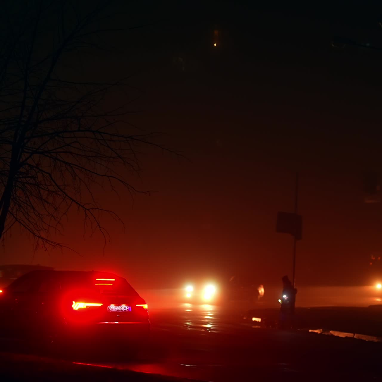 Red and yellow lights from the headlamps of cars on the motorways of the modern city at blackout period. Electricity outage at night