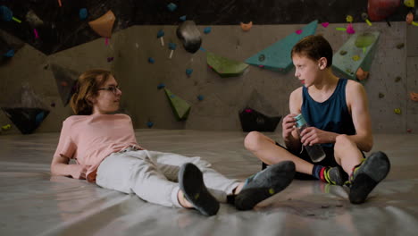 teenage boys resting in a climbing gym