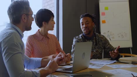 business executives discussing over laptop in conference room 4k