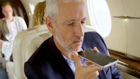 Businessman-talking-on-mobile-phone-in-private-jet-4k