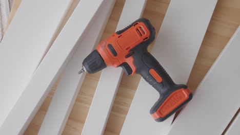 electric drill on white wood planks