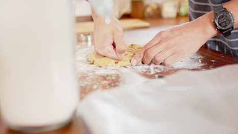 Biracial-man-wearing-christmas-hat,-making-christmas-cookies-in-kitchen-at-home,-slow-motion