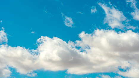 billowing clouds move across the azure sky in the dreamy time lapse sequence of the sky only