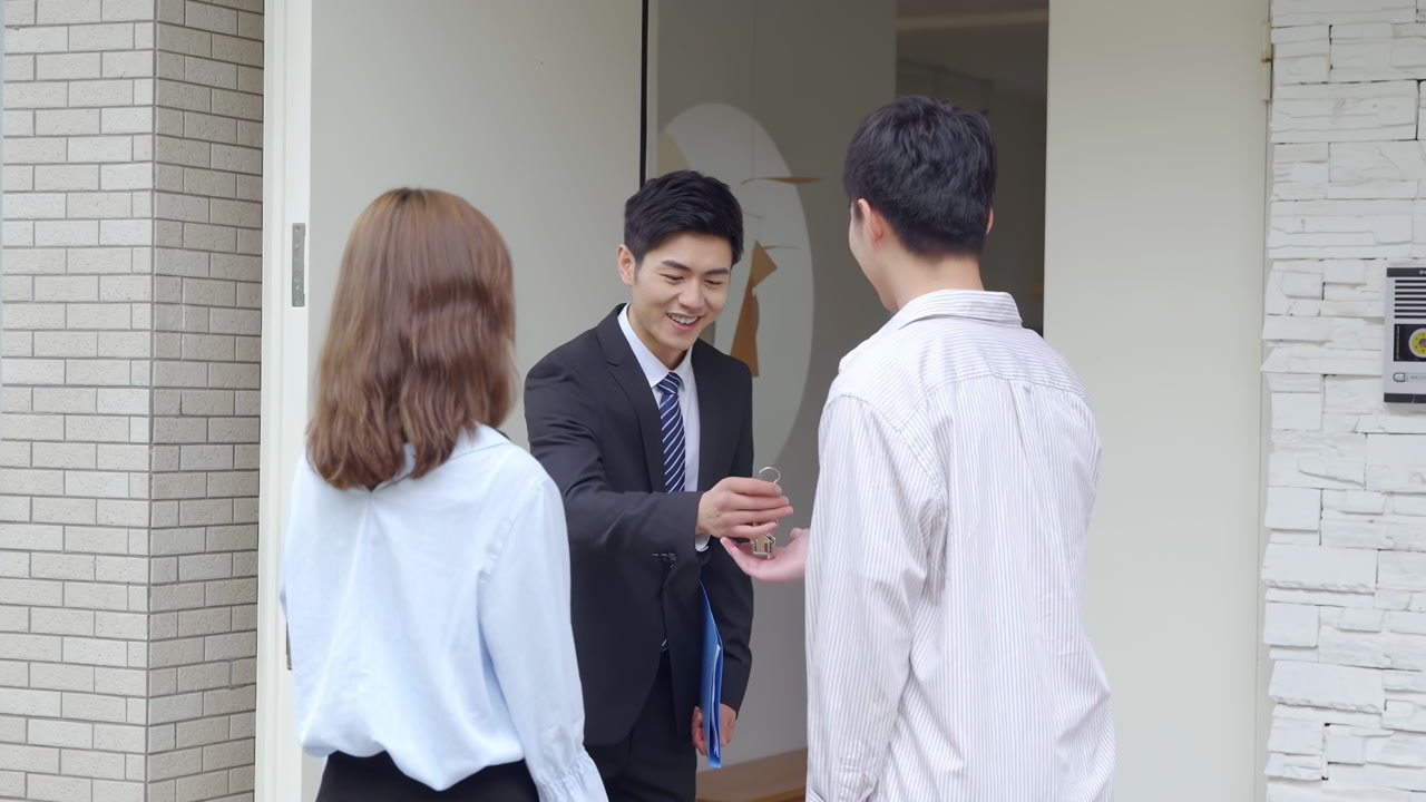 Salesperson realtor handing over keys to client to newly bought house or apartment, shaking hands after signing home purchase agreement to new residence wealthy couple, potential customers buy house