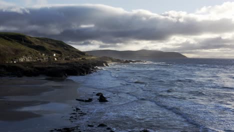 aerial - a rocky beach and a road next to it, coast of england, wide forward shot