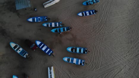 overhead shot of small boats on beach near todos santos, mexico - 4k establishing drone shot