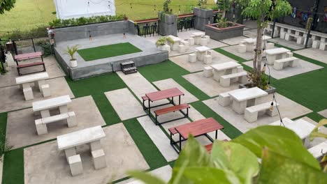the footage shows the coffee shop's outdoor concept customer tables and chairs, using modern aesthetic stone and wood.