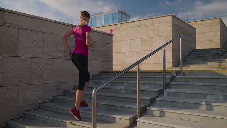 woman running up stairs in city