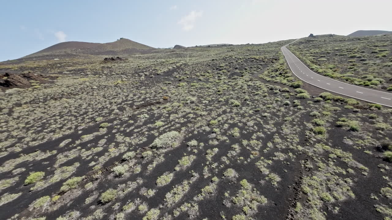 FPV drone soars over rocky Montaña de Lajio landscape, evoking adventure