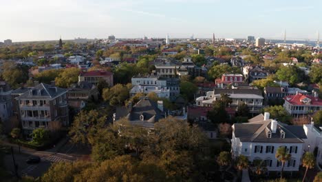 aerial rising and panning shot of antebellum mansions along the south battery waterfront during sunset in charleston, south carolina