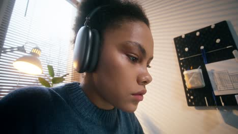 young woman studying with headphones