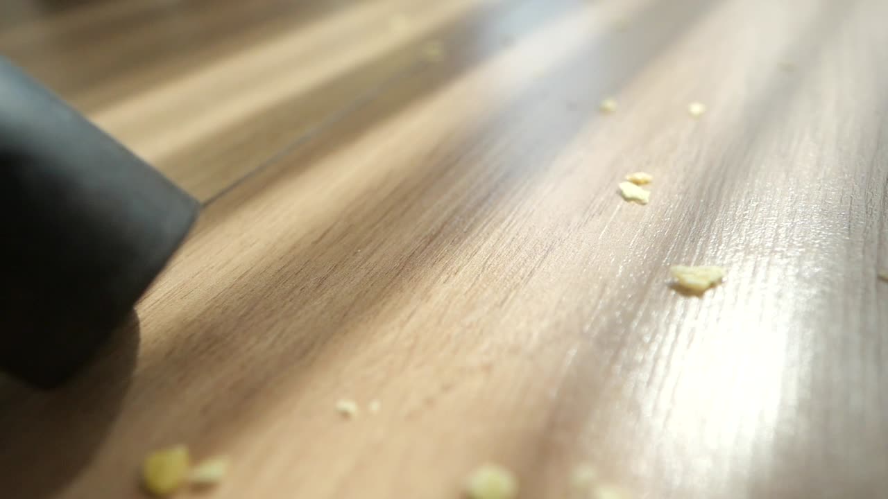 Cleaning Crumbs on Wood Floor with Vacuum Cleaner