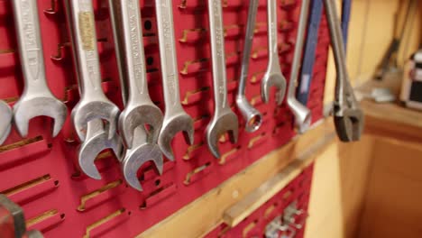 slider shot of tools arranged on a wall mount inside an engineering workshop