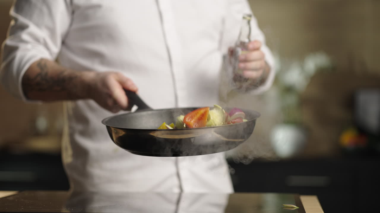 Chef cooking with a frying pan