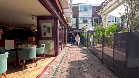 people walking past a cafe in brighton