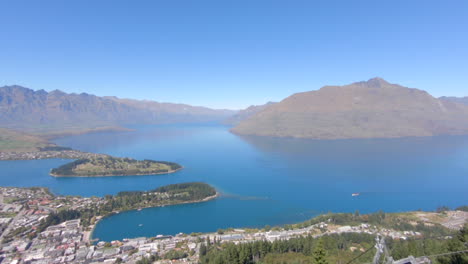 Wide-panning-shot-of-Queentstown-and-Lake-Wakatipu-with-the-mountains-in-the-background,-Queenstown,-New-Zealand