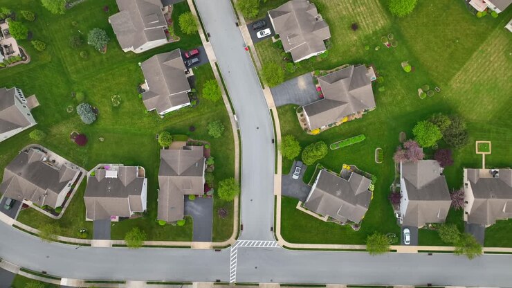 Aerial top down of noble housing area with villas and green grass in garden