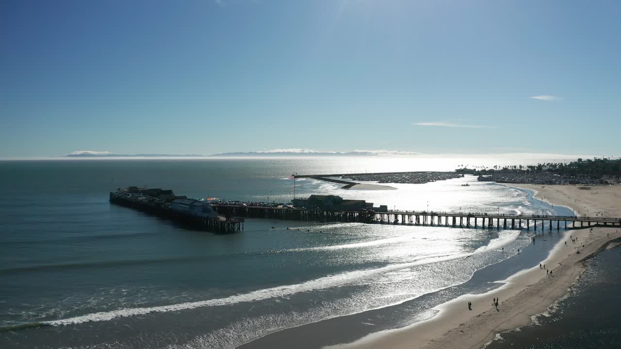 Aerial rising and panning shot of Stearns Wharf in Santa Barbara, California. 4K