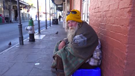 a homeless man sits on the street 2