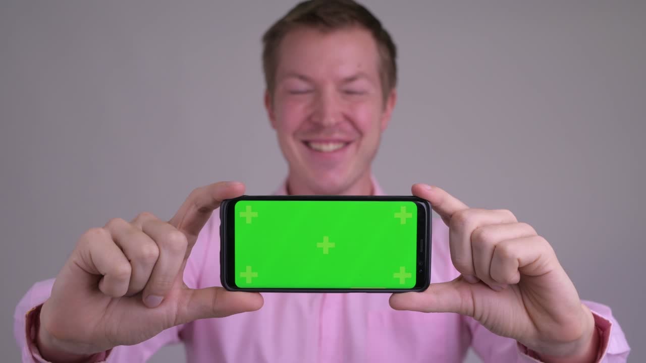 분홍색 셔츠와 함께 젊은 잘 생긴 사업가