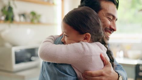 children, father and daughter hug in the kitchen