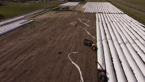 Tractors-taking-harvest-from-silo-bags-in-farm-of-Buenos-Aires-province