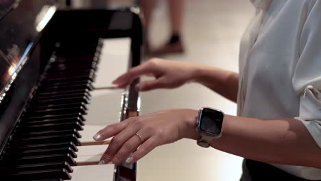 hands playing piano, showcasing musical performance