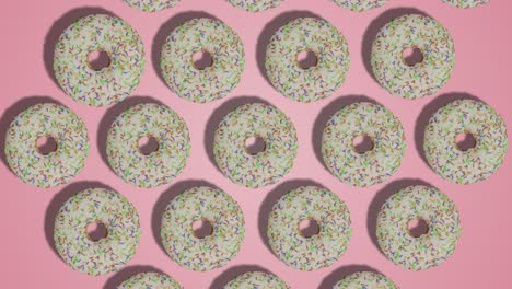 white chocolate glazed donuts appearing on pink background stop motion animation