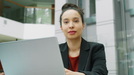 Portrait-of-Businesswoman-with-Laptop-in-Office-Center