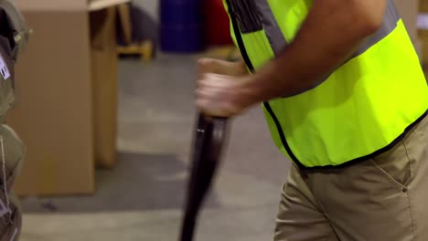 Warehouse-worker-putting-palette-on-trolley