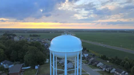 pushing backwards drone shot of the watertower in clarksville revealing downtown clarksville