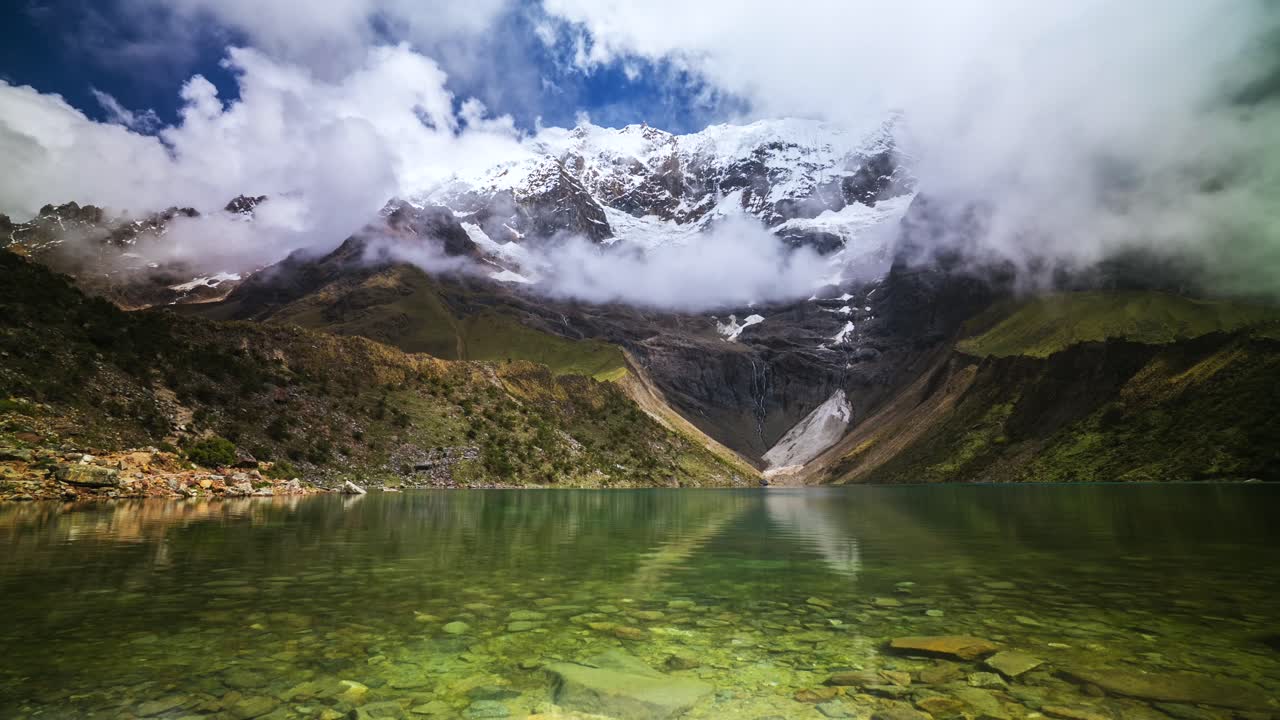 Lake Humantay glacial Laguna Humantay Peru Perú time lapse Peruvian Andes Mountain Range weather fog low cloud movement blue skies snow capped mountains glacier high altitude elevation Salcantay trek