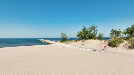 flying from the volleyball court posts to the distant south beachhead lighthouse in muskegon