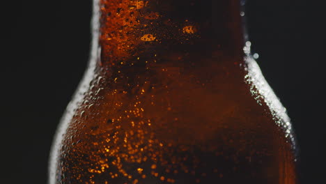 Close-Up-Of-Condensation-Droplets-On-Revolving-Bottle-Of-Cold-Beer-Or-Soft-Drink-2