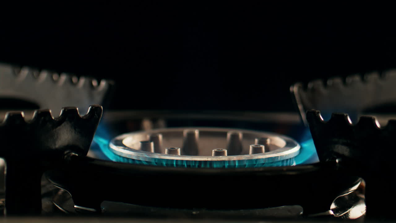 Close-up of a lit gas stove burner