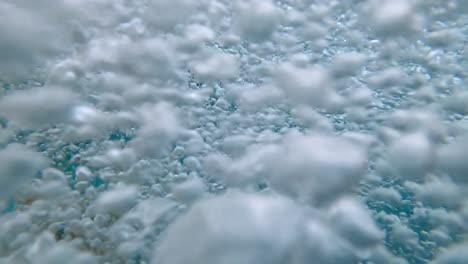 underwater shot of lots of air bubbles raising out of hot tub pool in spa centre