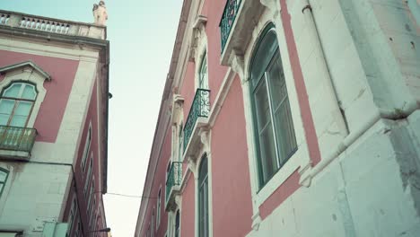 lisbon typical street facade with big windows at dawn in low angle traveling shot