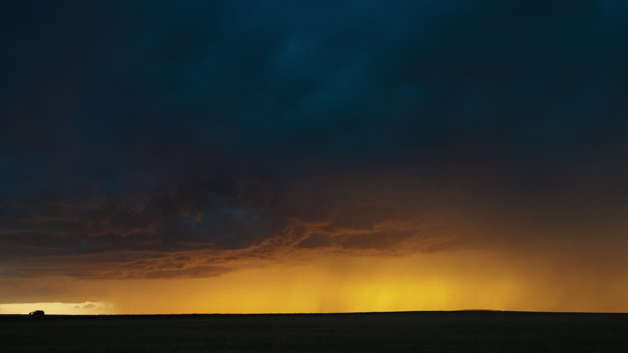 Dramatic Golden Light Under Dark Storm Clouds