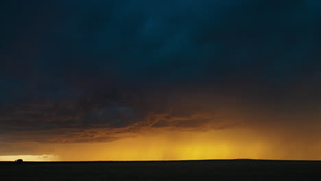 dramatic golden light under dark storm clouds