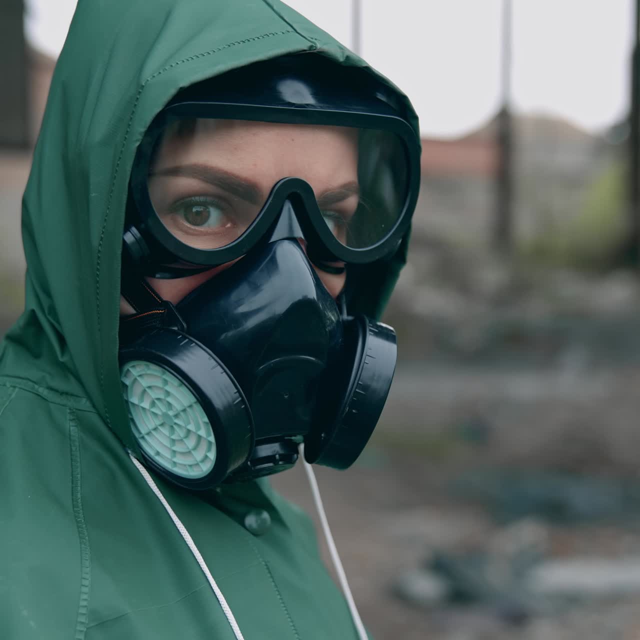 Environmental pollution and biological hazard. Human in gas mask near abandoned building