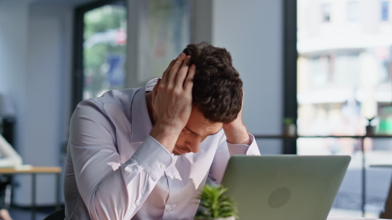 Stressed manager looking laptop dissatisfied problem closeup. Frustrated man