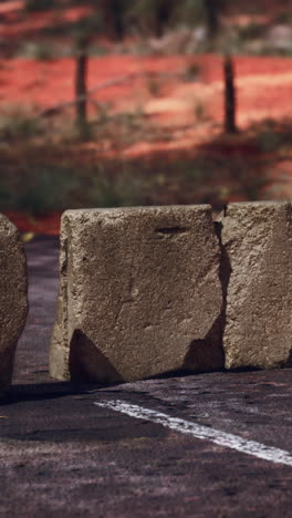 close up of a broken concrete roadblock on a rural road