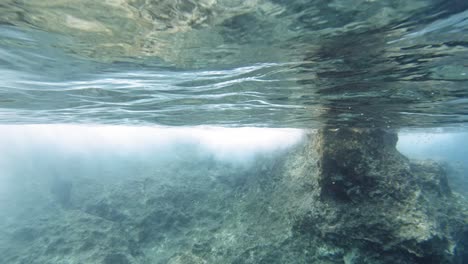 crystal clear underwater shot of paralia emplise beach during the day, in greece