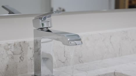 close look at a modern faucet in action