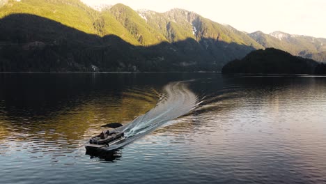 aerial drone shot of boat in indian arm, an inlet ocean in british columbia, canada