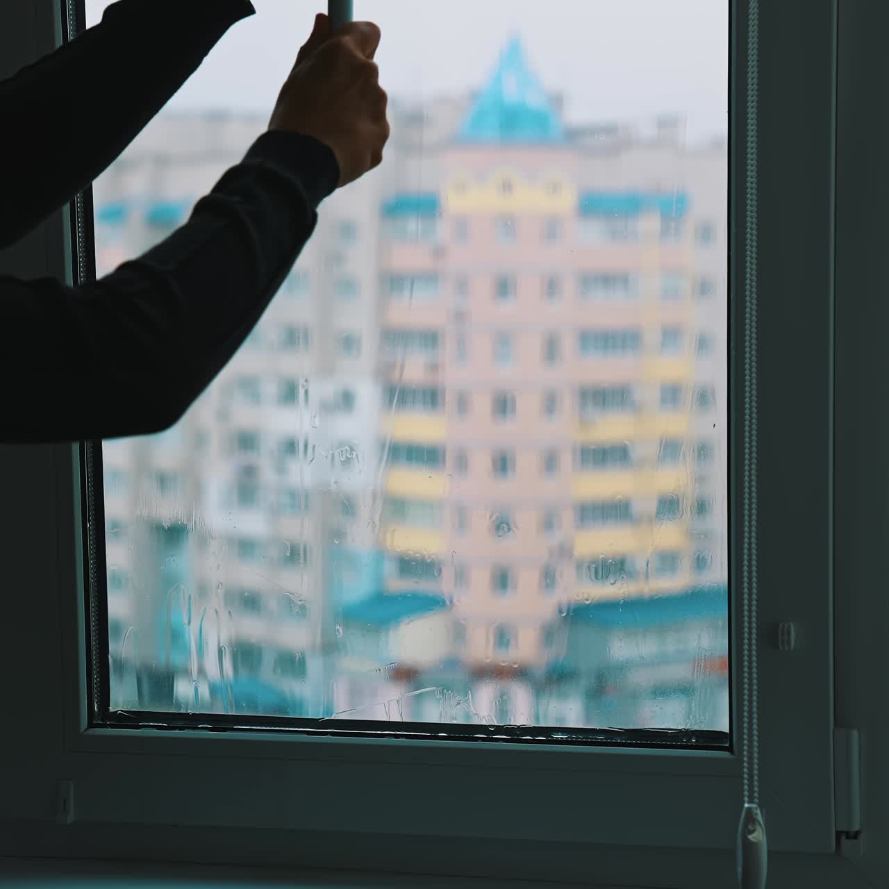 Man cleaning window with special equipment. Professional cleaning window indoor