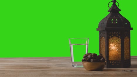 tracking shot of lantern dates and water in front of green screen