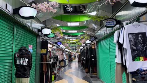 colorful indoor market ceiling with hanging cherry blossoms and japanese lanterns overhead