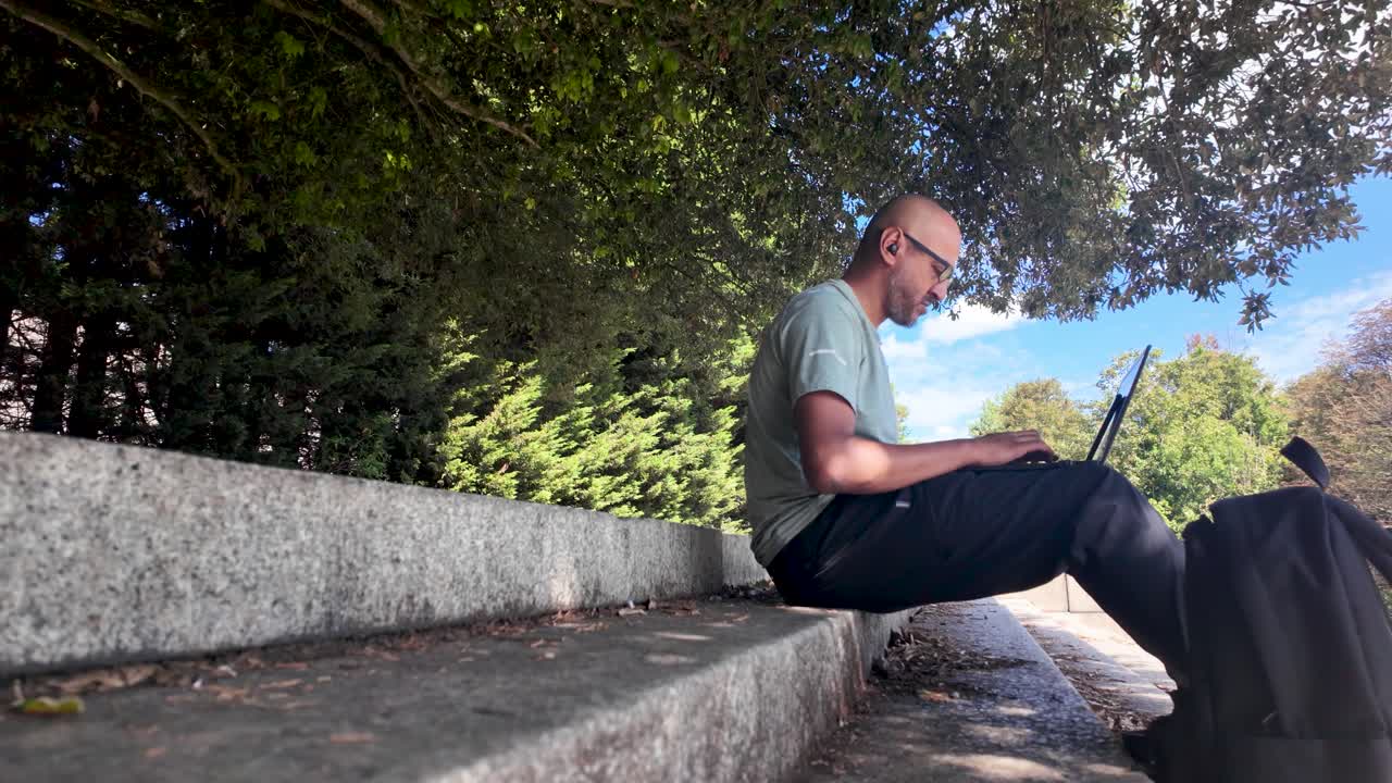 Man Working on Laptop Outdoors in Park